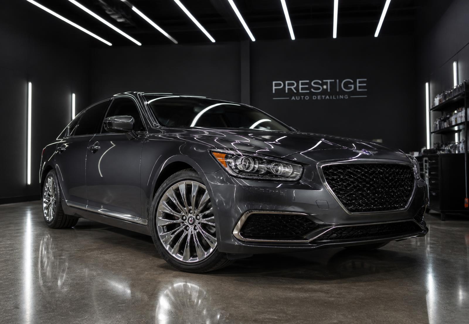 Polished luxury sedan in a premium detailing studio — view 2