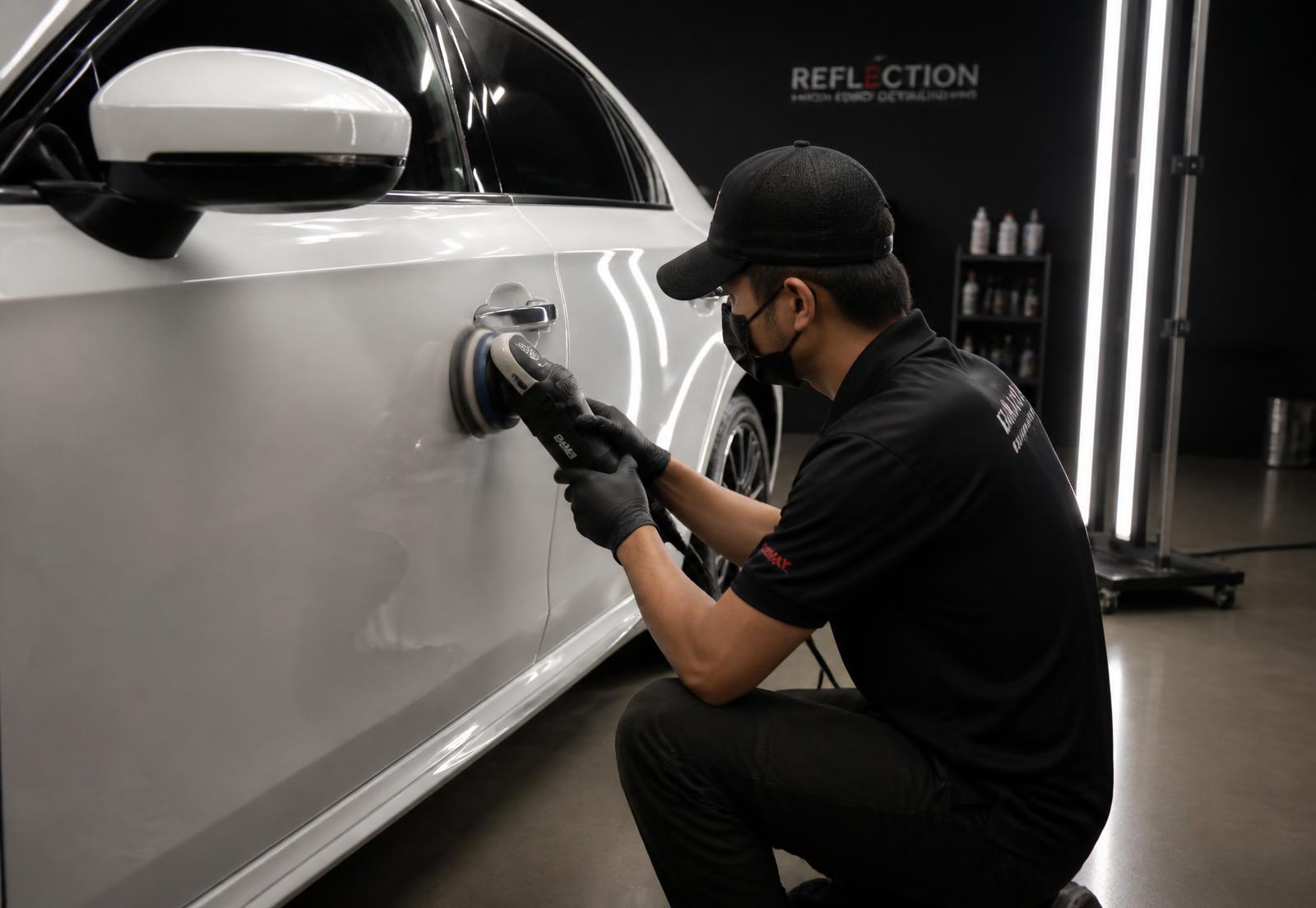 Polished luxury sedan in a premium detailing studio — view 3
