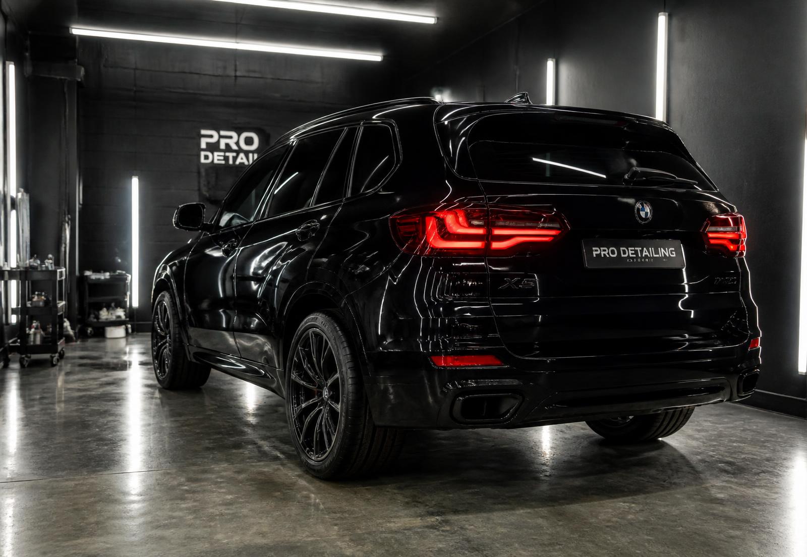Polished luxury sedan in a premium detailing studio — view 4